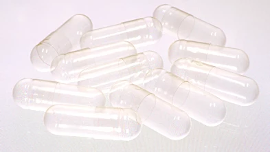 Clear gelatin capsules against a white background.