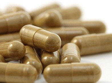 Small pile of capsules filled with brown material